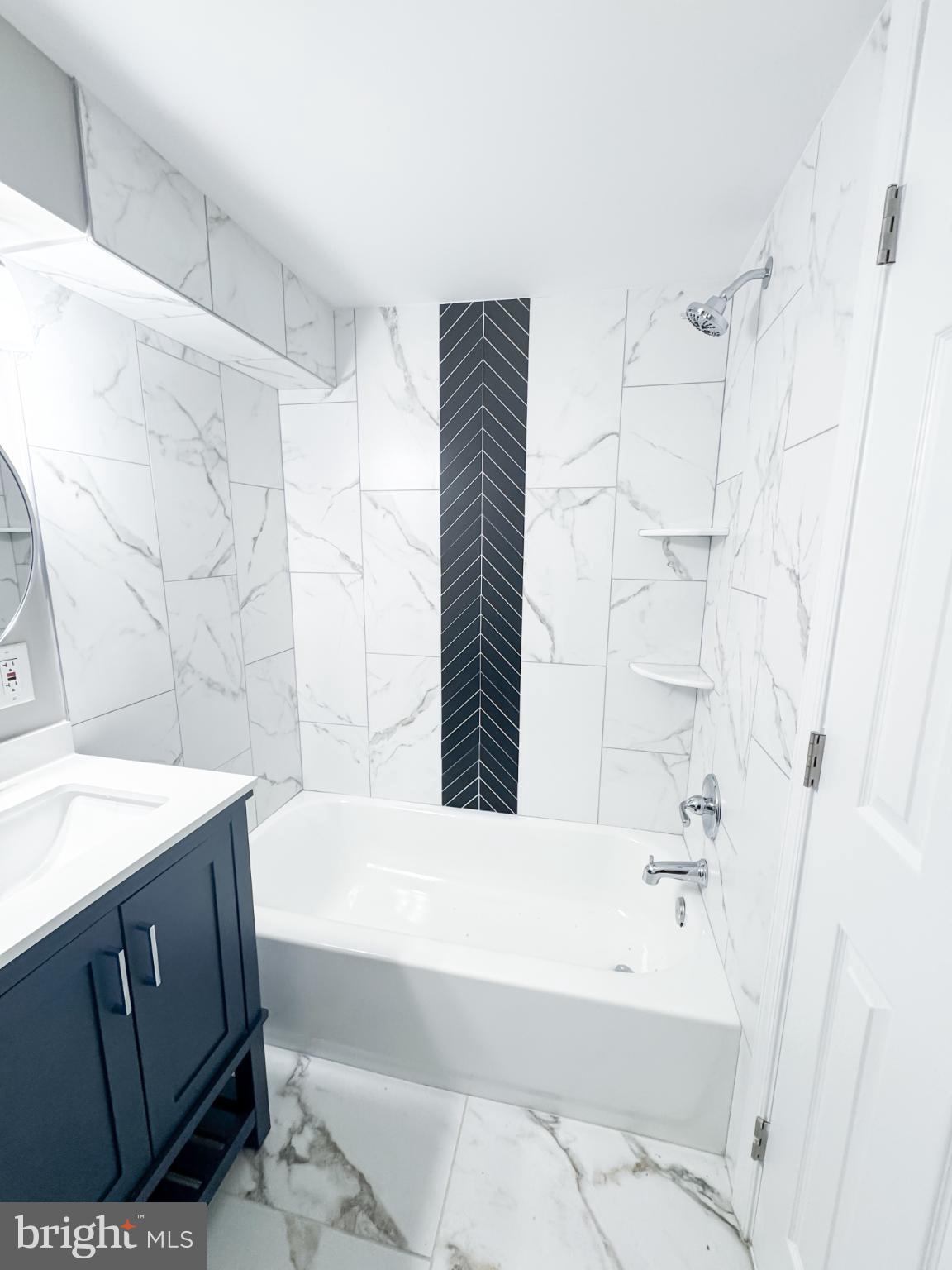 4105 30th Street Mount Rainier, MD 20712 - Photo 85 of 98 a bathroom with a bathtub a sink and a shower