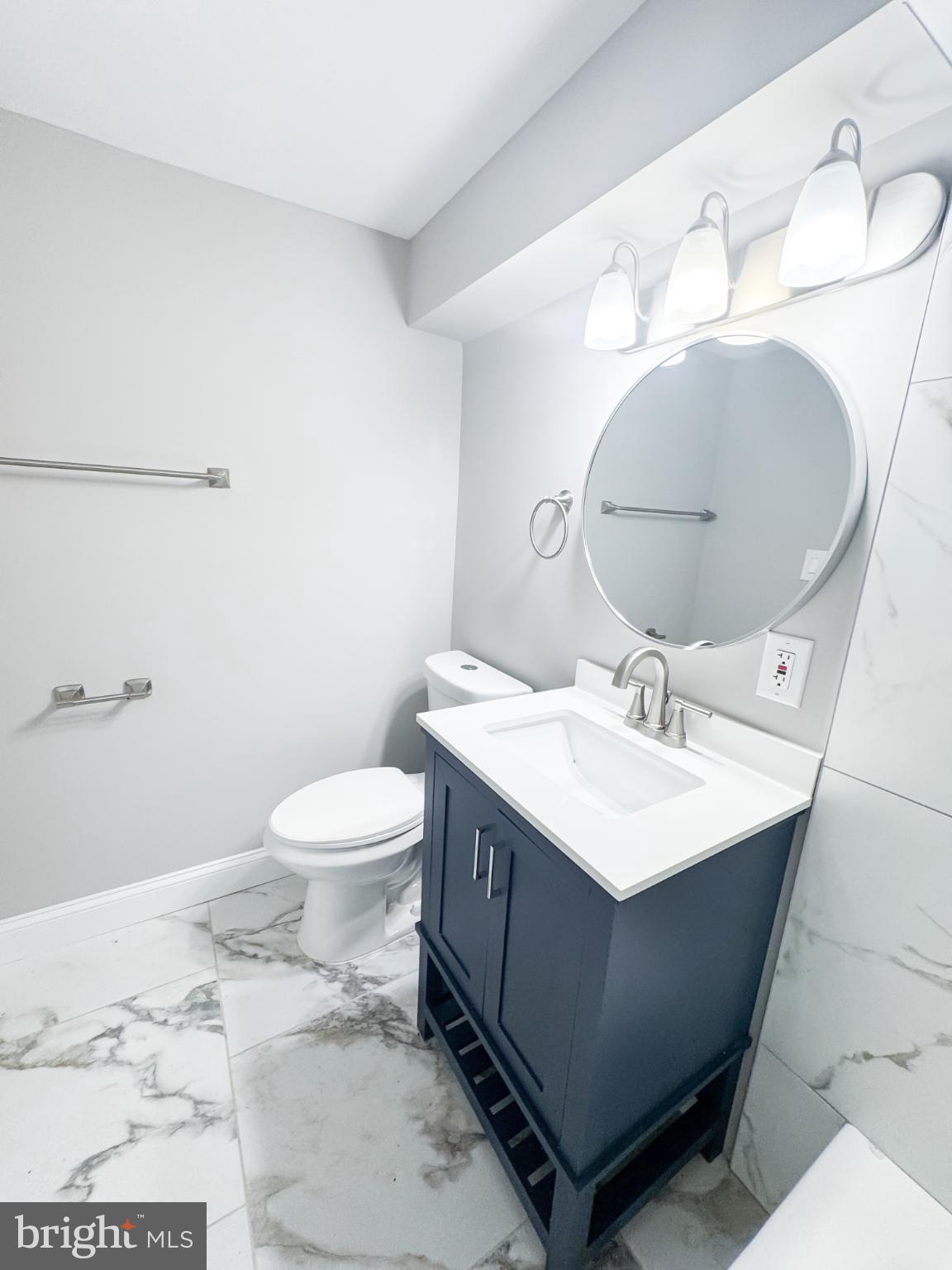 4105 30th Street Mount Rainier, MD 20712 - Photo 87 of 98 a bathroom with a sink mirror vanity and toilet