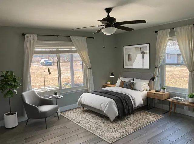 a living room with furniture a window and a potted plant