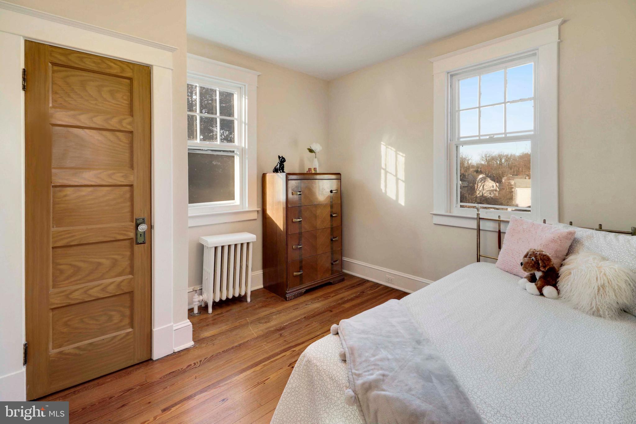 5314 Brabant Road Baltimore, MD 21229 - Photo 14 of 22 a bedroom with a bed closet and wooden floor
