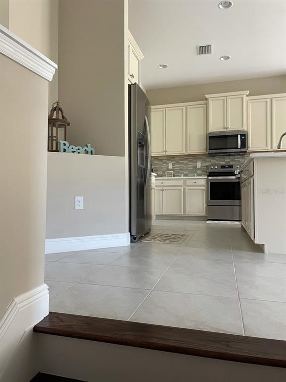 10425 Pilothouse Circle, Unit 130 Placida, FL 33946 - Photo 12 of 76 a kitchen with stainless steel appliances granite countertop a refrigerator a stove and a sink