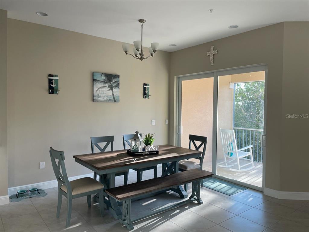 10425 Pilothouse Circle, Unit 130 Placida, FL 33946 - Photo 21 of 76 a dining room with furniture a chandelier and wooden floor