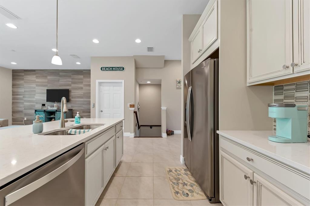 10425 Pilothouse Circle, Unit 130 Placida, FL 33946 - Photo 26 of 76 a kitchen with stainless steel appliances sinks a refrigerator and a counter top space