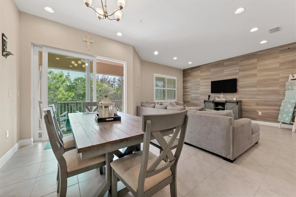 10425 Pilothouse Circle, Unit 130 Placida, FL 33946 - Photo 38 of 76 a dining room with furniture a window and a flat screen tv
