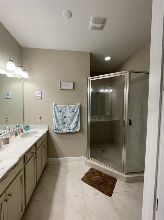10425 Pilothouse Circle, Unit 130 Placida, FL 33946 - Photo 41 of 76 a spacious bathroom with a mirror a shower and vanity