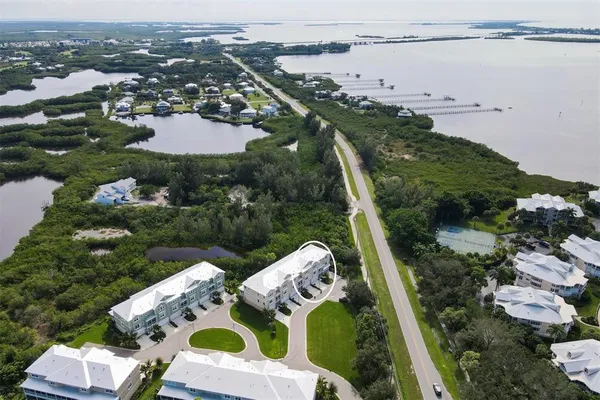 an aerial view of a house with a garden and lake view