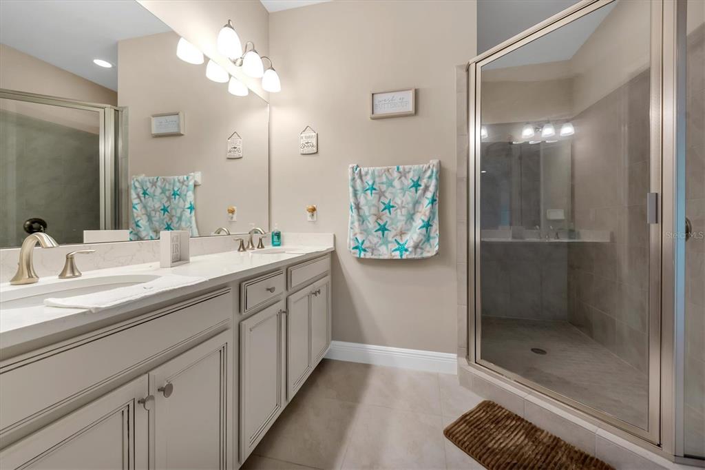 10425 Pilothouse Circle, Unit 130 Placida, FL 33946 - Photo 59 of 76 a bathroom with a double vanity sink mirror and shower