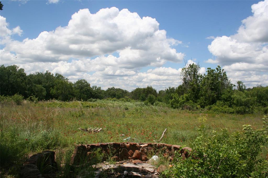 215 Buzbee Road Palo Pinto, TX 76484 - Photo 4 of 8 a view of a lake with houses in the back