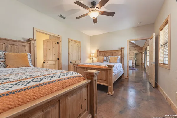 a bedroom with bed and wooden floor