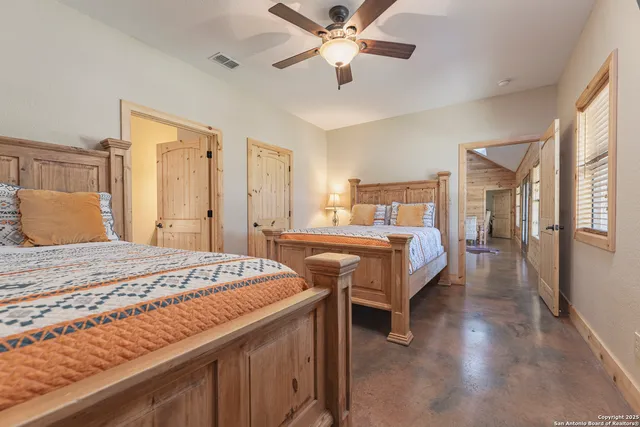 a bedroom with bed and wooden floor