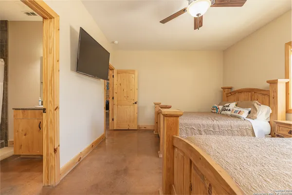 a bedroom with a bed and a flat screen tv