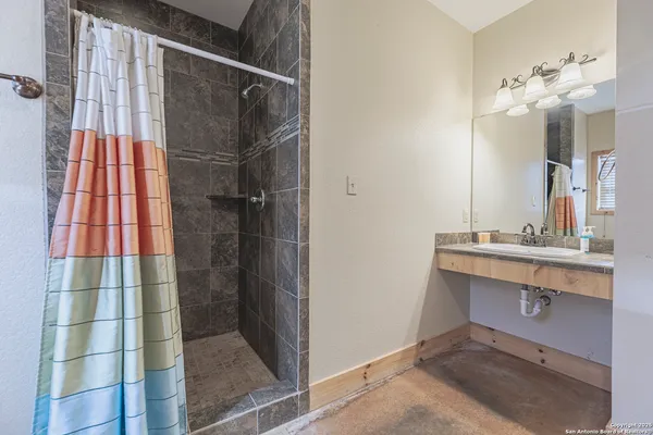 a bathroom with a sink and mirror