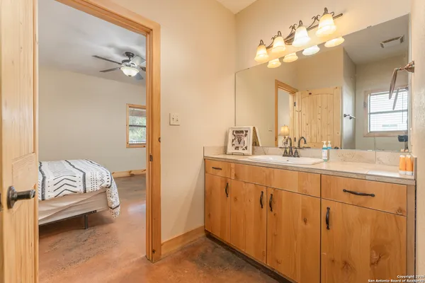 a spacious bathroom with a double vanity sink and a mirror
