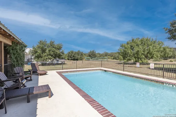 a view of a swimming pool with a lounge chair