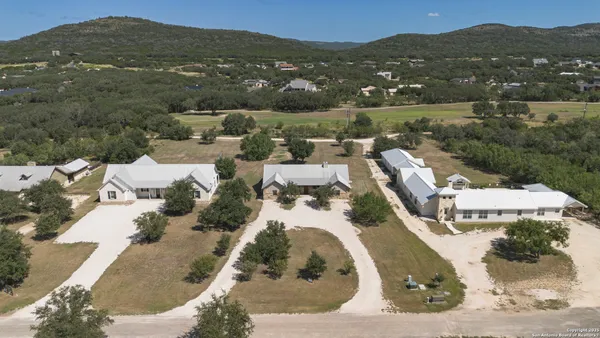 an aerial view of a house with a mountain