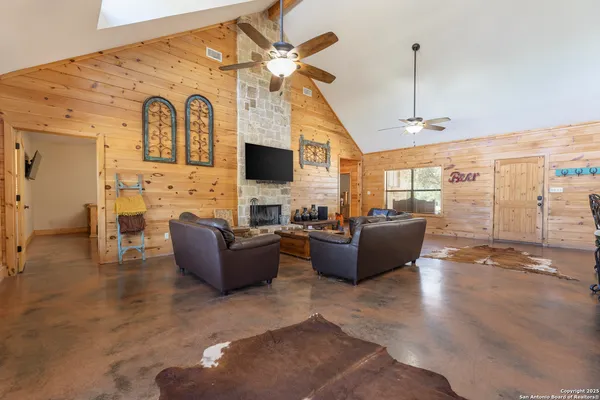 a living room with fireplace furniture and a flat screen tv