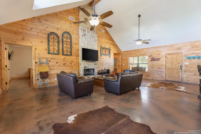 a living room with fireplace furniture and a flat screen tv