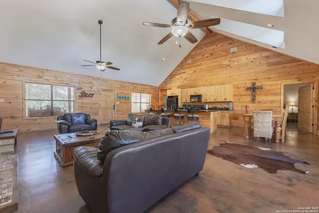 a living room with lots of furniture and a chandelier