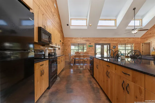 a kitchen with granite countertop lots of counter top space and wooden floor