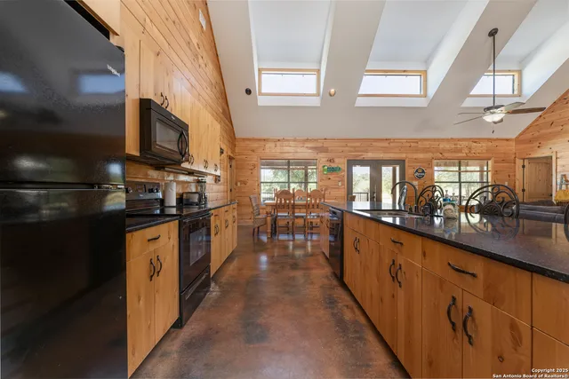 a kitchen with granite countertop lots of counter top space and wooden floor