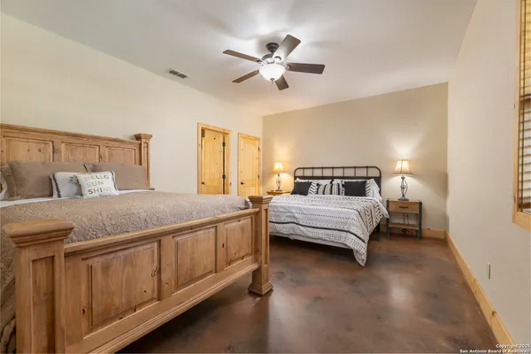 a bedroom with a large bed and a chandelier