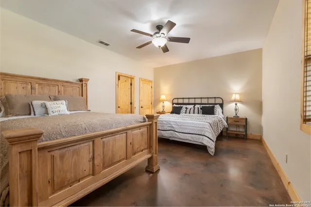 a bedroom with a large bed and a chandelier