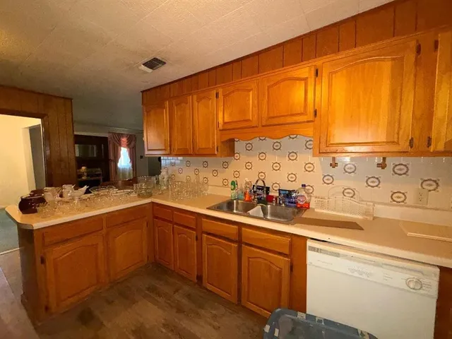 a kitchen with a sink stove and cabinets
