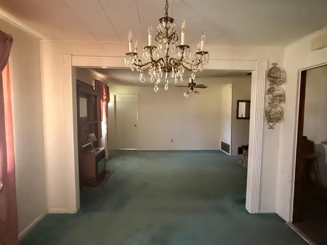 a view of a chandelier in big room and chandelier