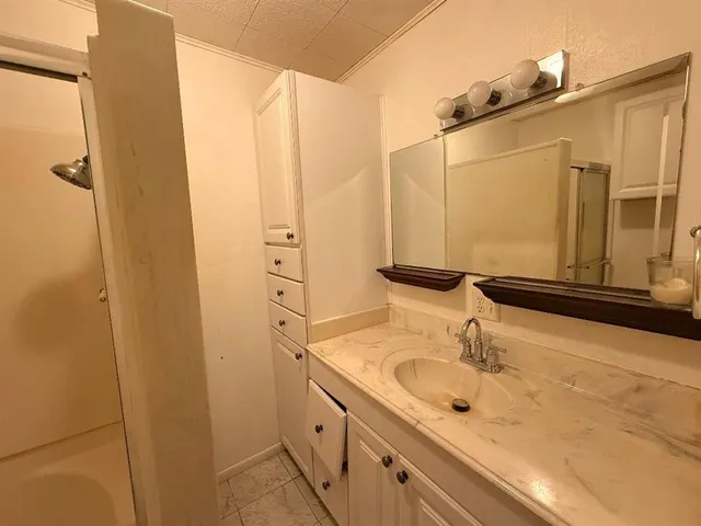 a bathroom with a sink and a mirror