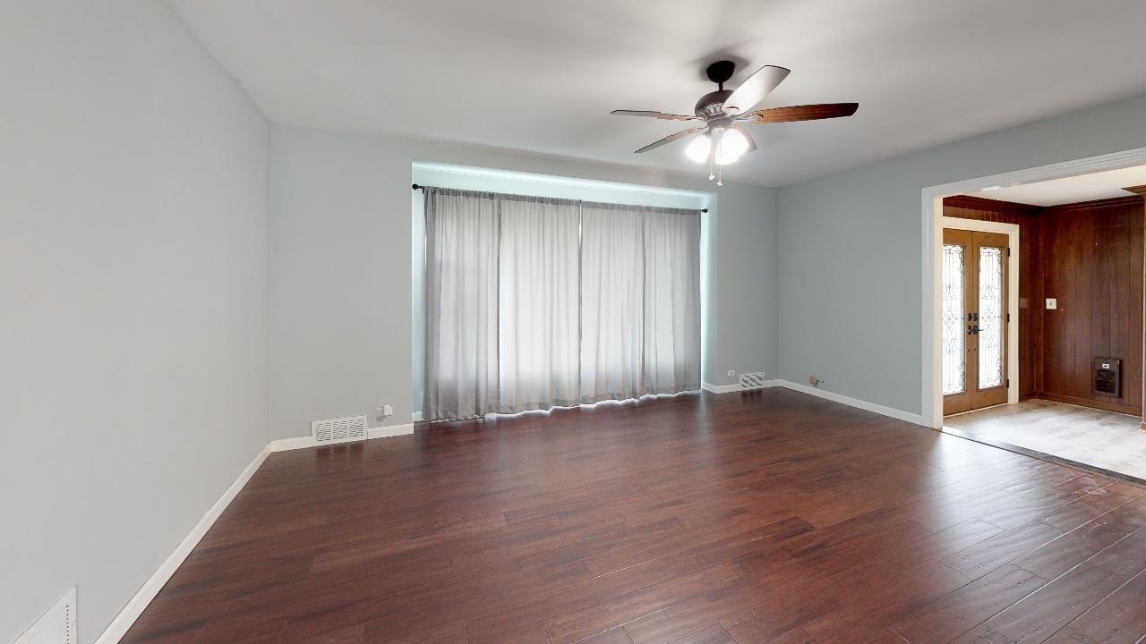 7624 Forest Avenue Munster, IN 46321 - Photo 11 of 37 a view of an empty room with wooden floor and a window