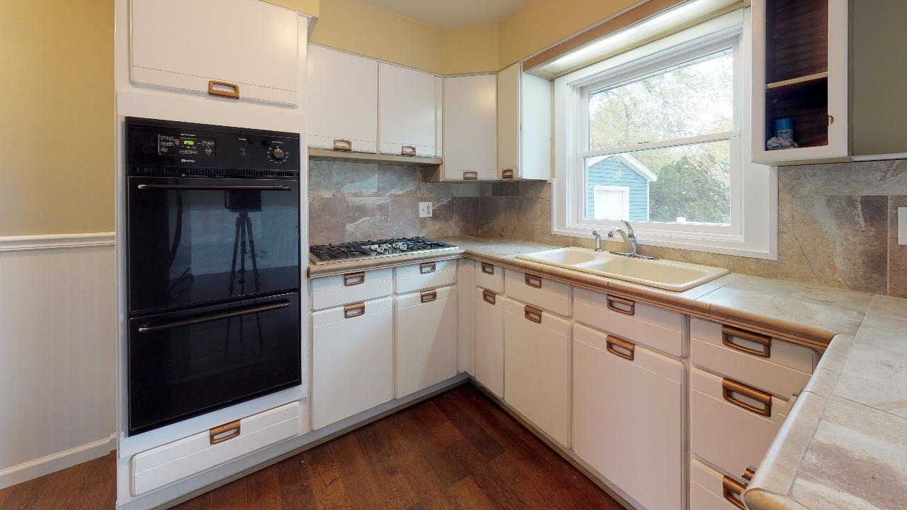 7624 Forest Avenue Munster, IN 46321 - Photo 18 of 37 a kitchen with white cabinets and appliances