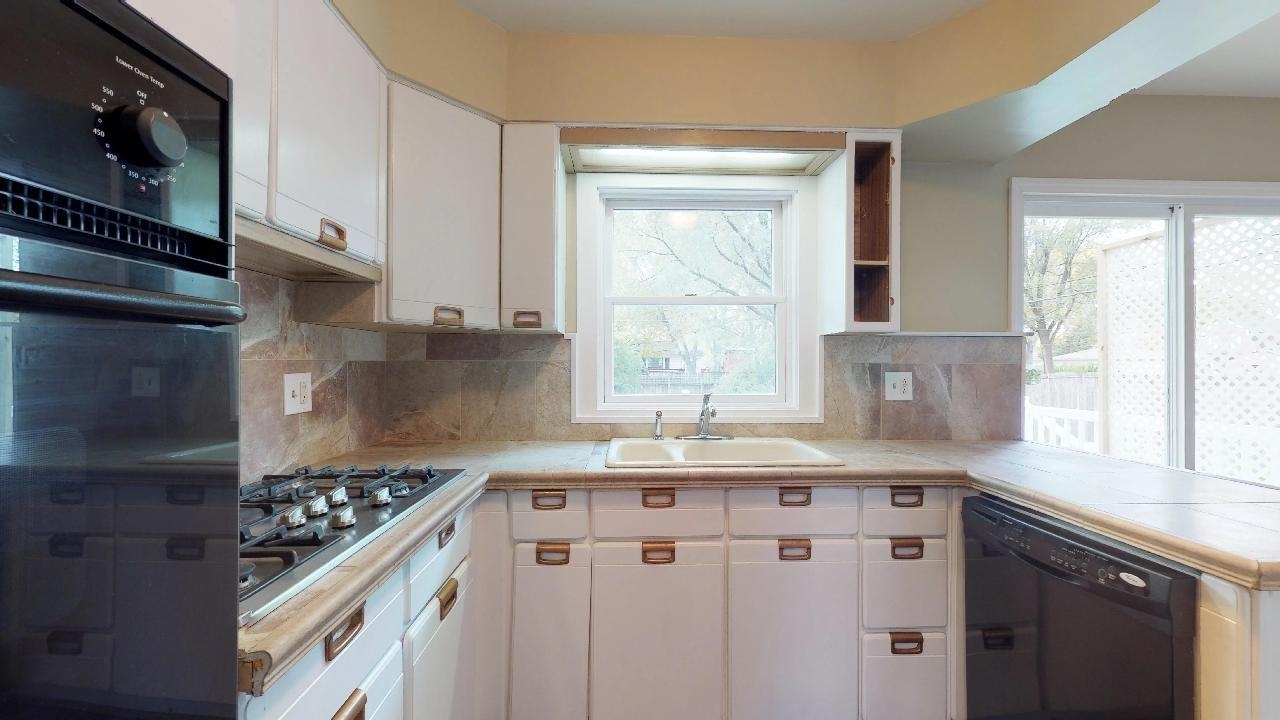 7624 Forest Avenue Munster, IN 46321 - Photo 19 of 37 a kitchen with granite countertop a sink stove and cabinets