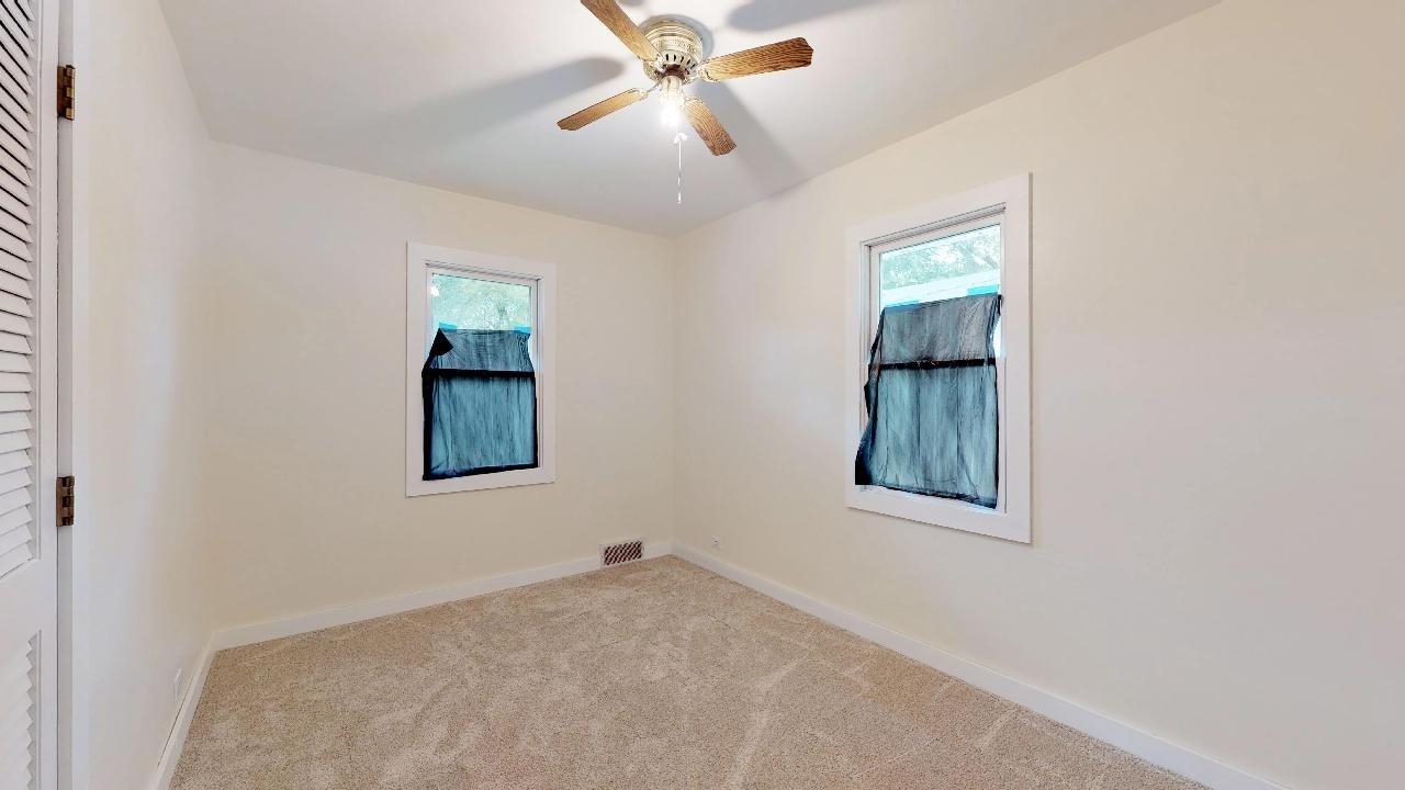7624 Forest Avenue Munster, IN 46321 - Photo 27 of 37 an empty room with windows and fan