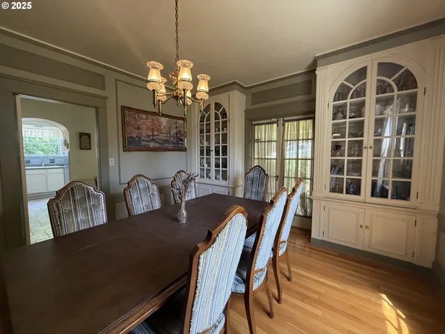 a view of a dining room with furniture and chandelier