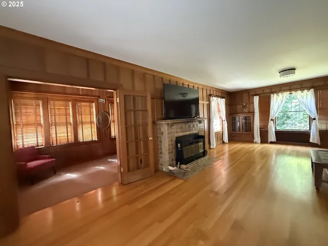 a living room with fireplace furniture and a flat screen tv