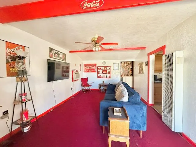 a room with wooden floor pool table and windows