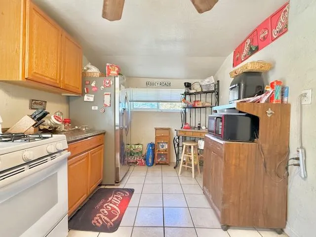 a kitchen with a refrigerator and a stove top oven