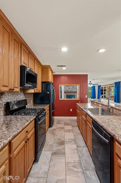 225 Marie Road Ringgold, LA 71068 - Photo 30 of 40 Kitchen featuring wood cabinetry, stone countertops, black appliances, tile backsplash, and recessed lighting