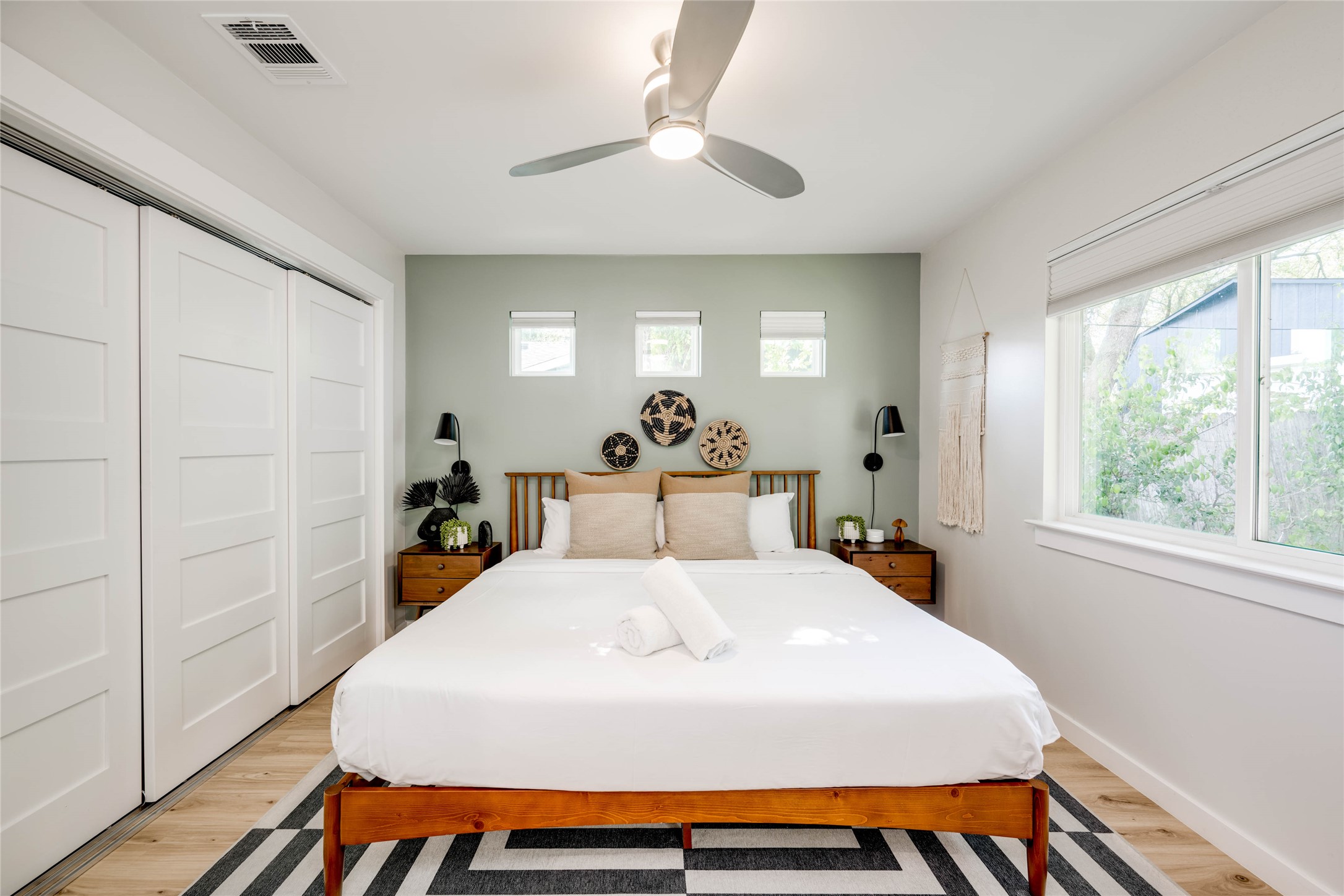 2516 Friar Tuck Lane Austin, TX 78704 - Photo 19 of 40 a bedroom with a bed and a chandelier