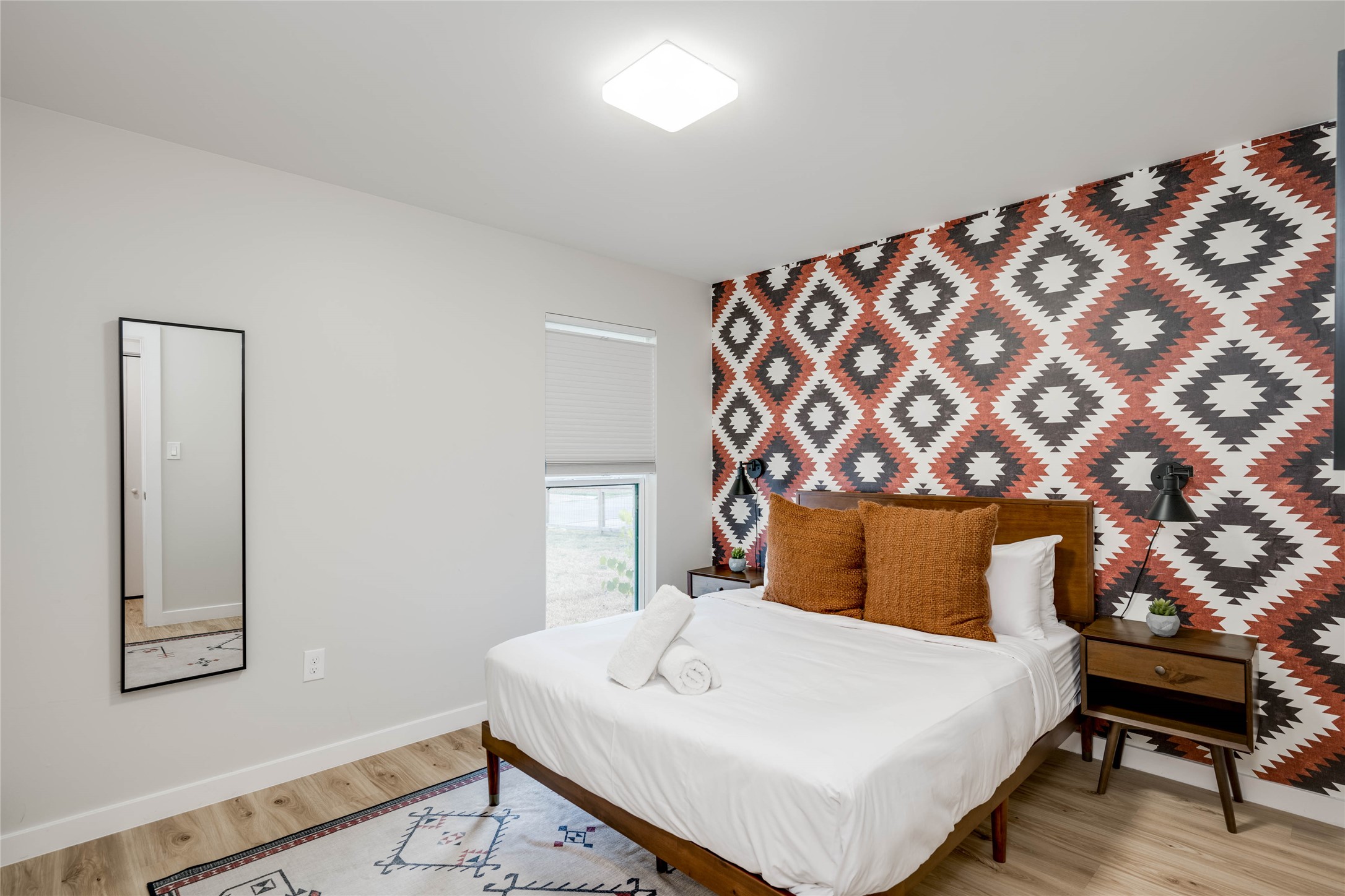 2516 Friar Tuck Lane Austin, TX 78704 - Photo 24 of 40 a bedroom with a bed and a lamp on table