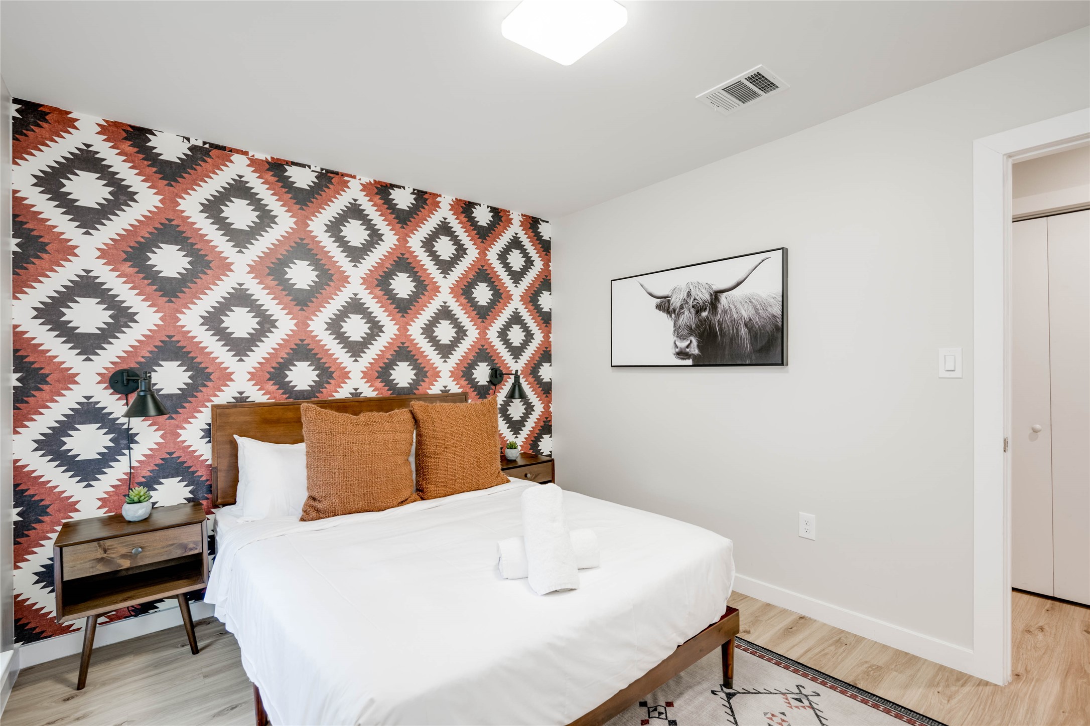 2516 Friar Tuck Lane Austin, TX 78704 - Photo 25 of 40 a bedroom with a bed and a lamp on dresser