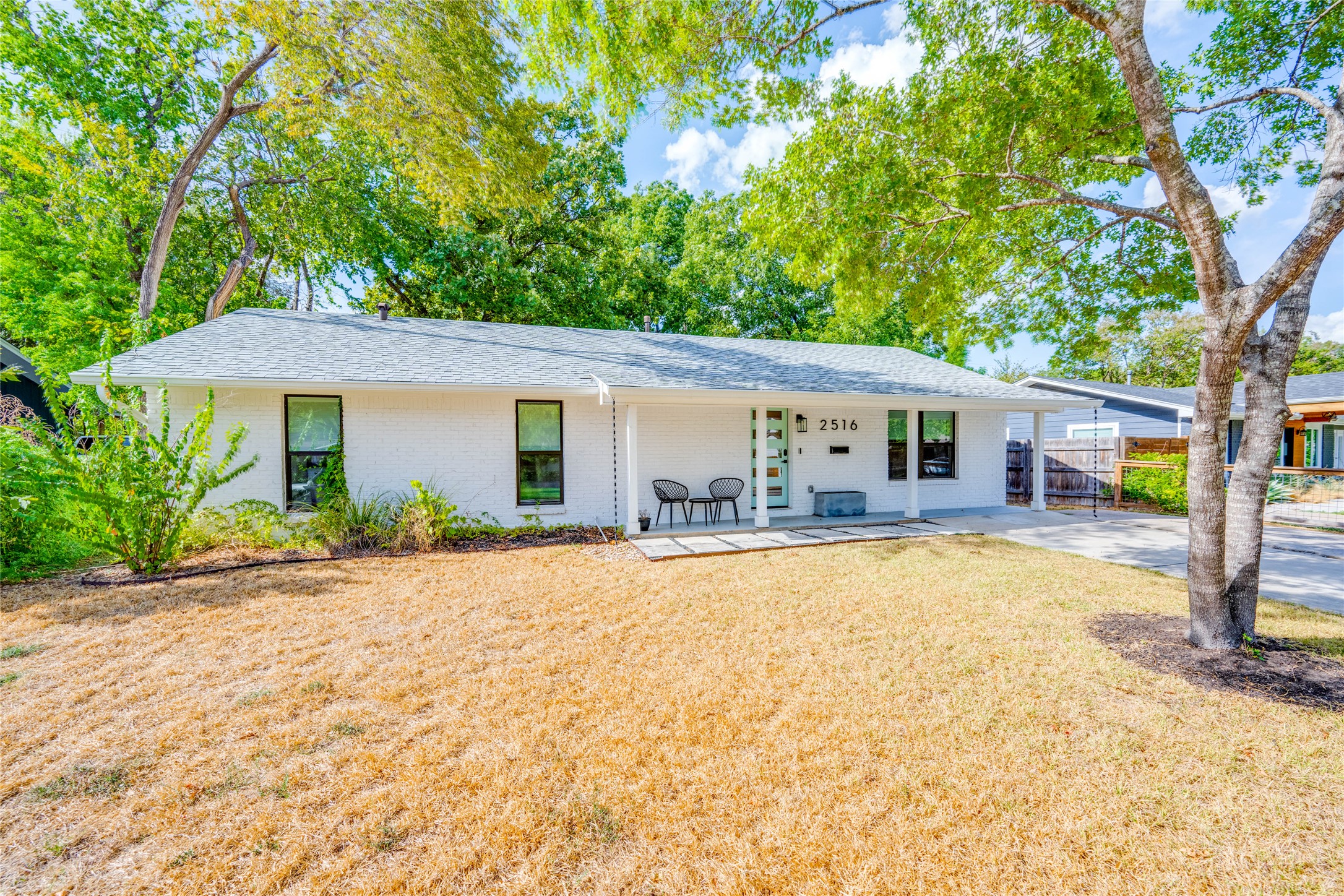 2516 Friar Tuck Lane Austin, TX 78704 - Photo 39 of 40 a front view of a house with a porch and a yard