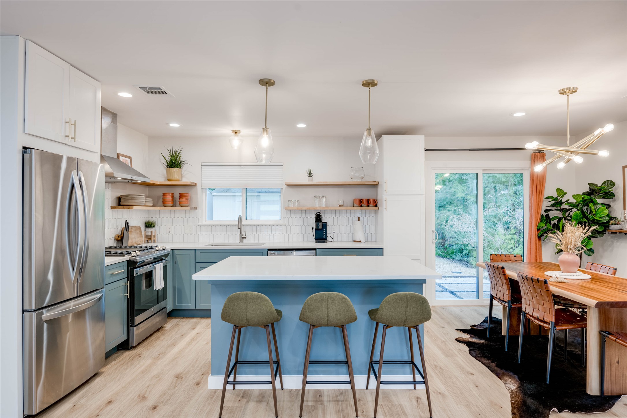 2516 Friar Tuck Lane Austin, TX 78704 - Photo 5 of 40 a kitchen with stainless steel appliances granite countertop a stove a refrigerator a oven a sink a dining table and chairs with wooden floor