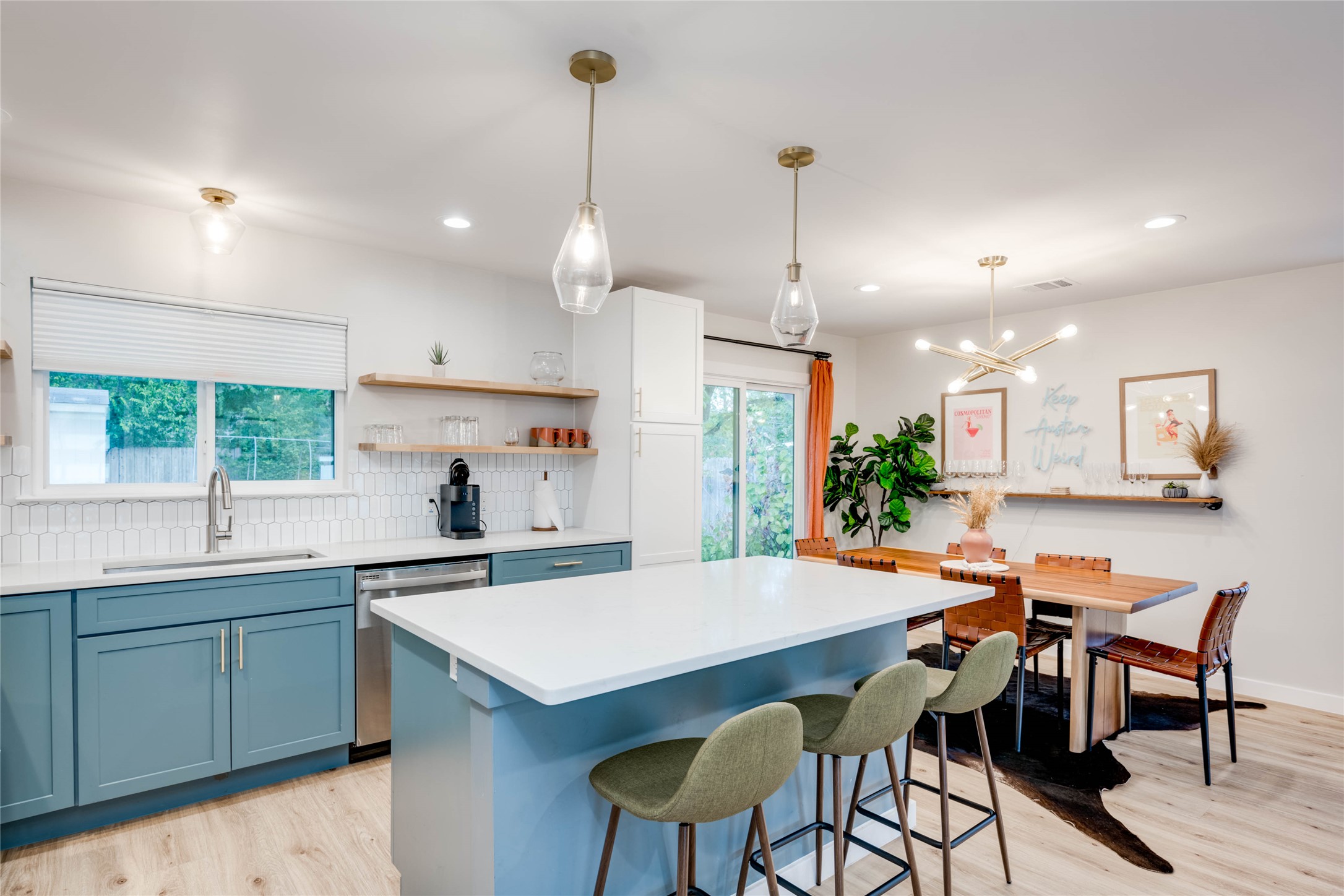 2516 Friar Tuck Lane Austin, TX 78704 - Photo 6 of 40 a kitchen with stainless steel appliances kitchen island a table chairs sink and wooden floor