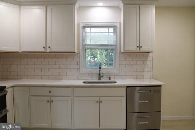 a kitchen with a sink and cabinets