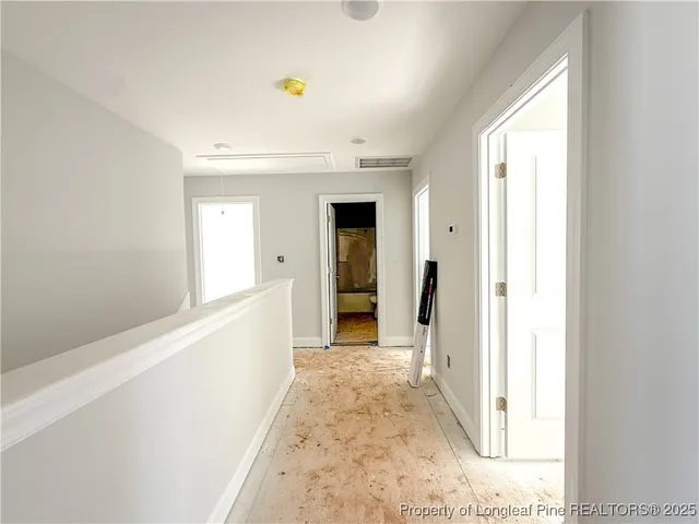 a view of a hallway with wooden shelves