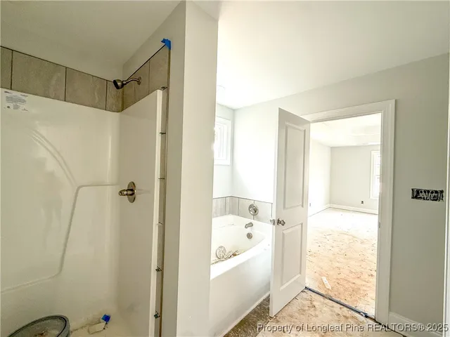 a bathroom with a tub shower and sink
