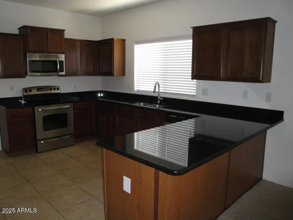 a kitchen with a sink and microwave