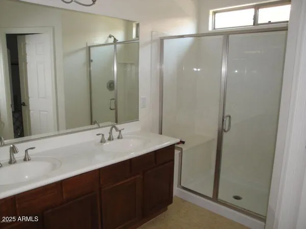 a bathroom with a granite countertop sink shower and a mirror