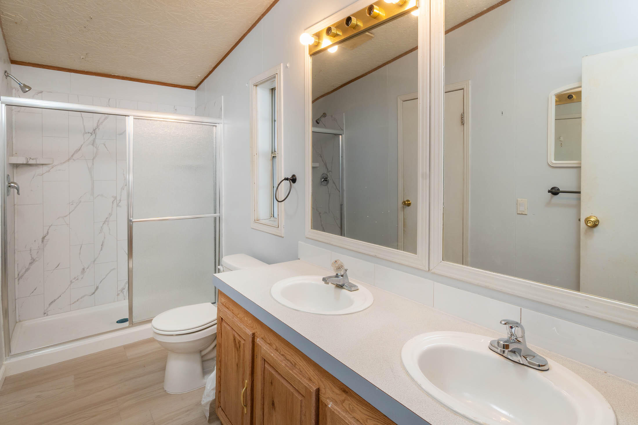 25907 South Cooper Street Bend, OR 97701 - Photo 16 of 34 a bathroom with a sink toilet and shower